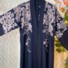 Black Dubai abaya with earthy-tone floral embroidery on shoulders and sleeves