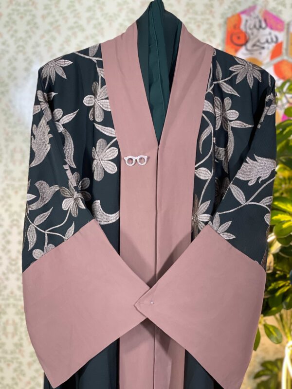 Dark green Dubai abaya with soft pink floral embroidery and contrast sleeve cuffs