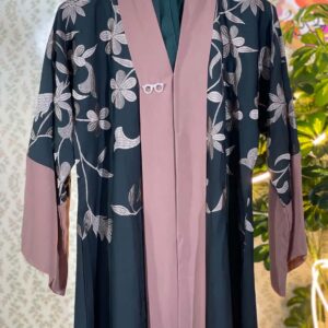Dark green Dubai abaya with soft pink floral embroidery and contrast sleeve cuffs