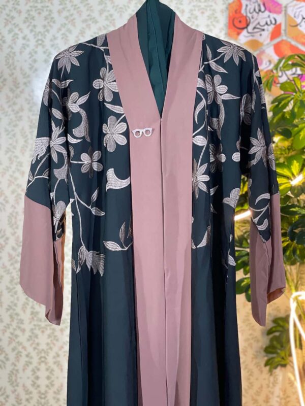 Dark green Dubai abaya with soft pink floral embroidery and contrast sleeve cuffs